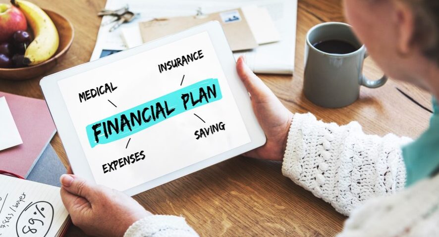 Financial planning tools and documents spread on a desk, symbolizing the strategic approach in crafting a personal financial plan with personal finance secrets.